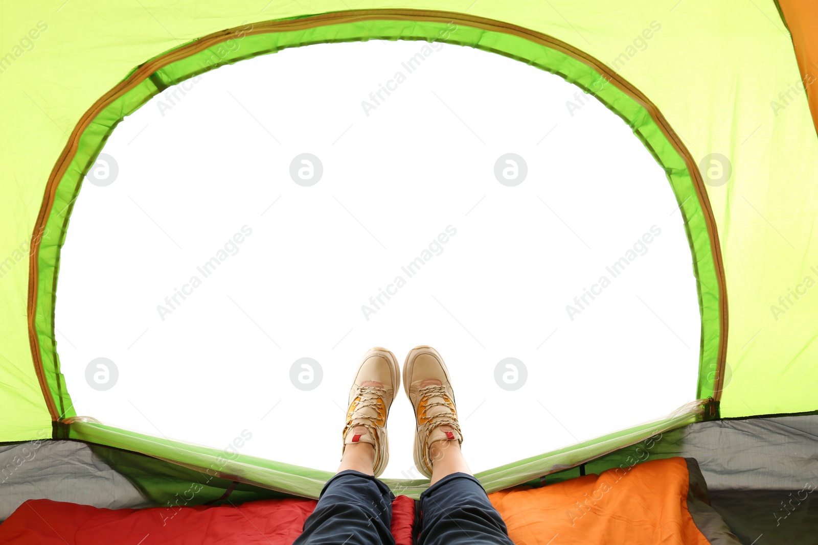 Photo of Closeup of female in camping tent on white background, view from inside