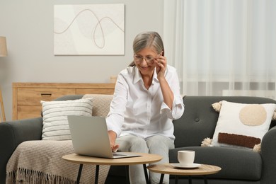 Photo of Beautiful senior woman using laptop at home