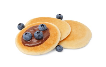 Photo of Tasty pancakes with chocolate spread and blueberries isolated on white