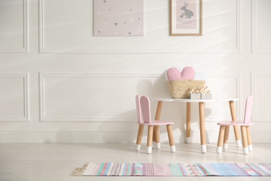 Photo of Baby room interior with stylish furniture and toys