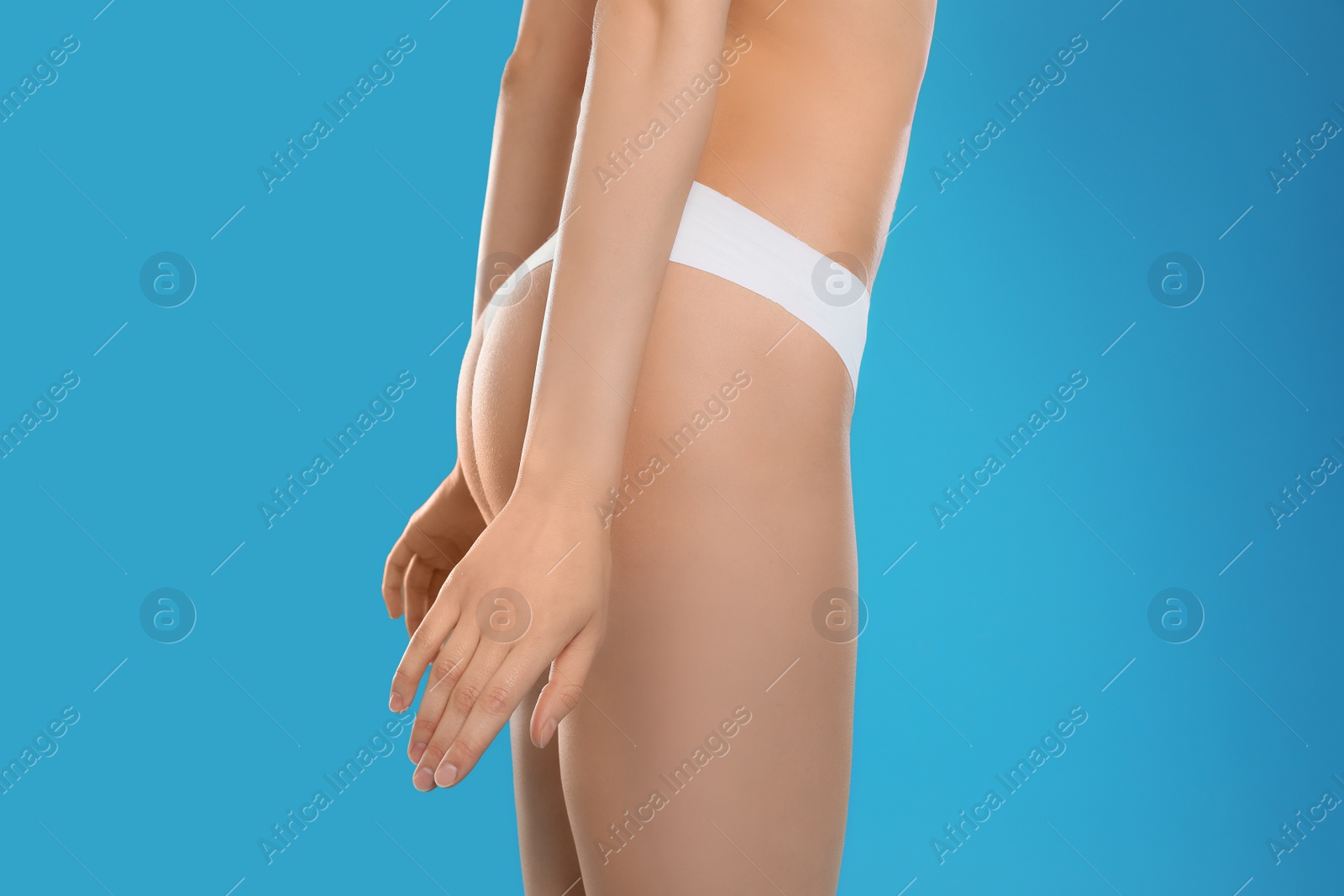 Photo of Slim young woman with smooth gentle skin on color background, closeup. Beauty and body care concept