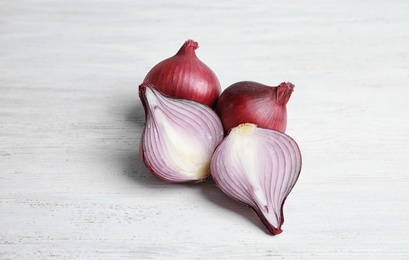 Ripe cut red onions on wooden table