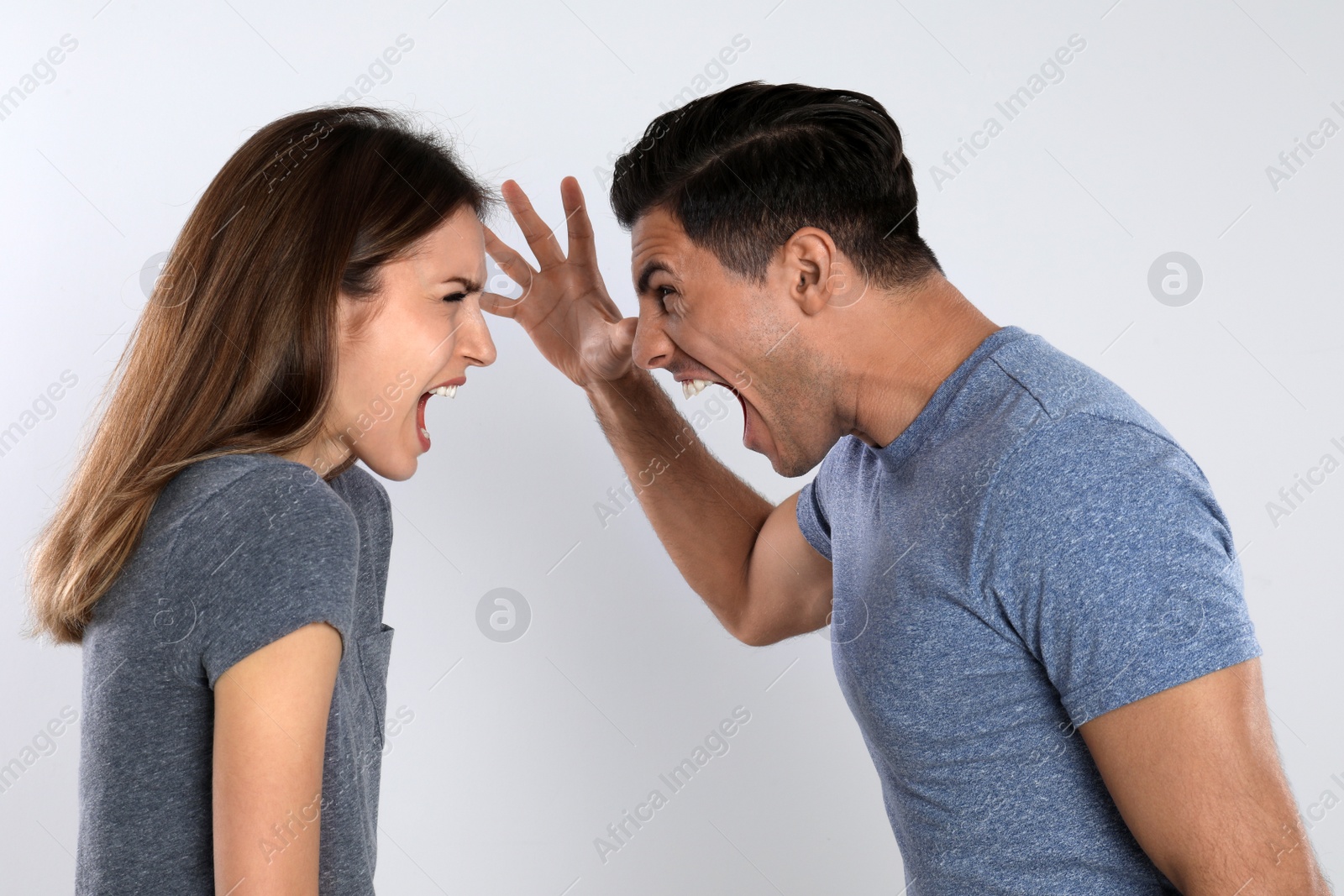 Photo of Couple quarreling on light background. Relationship problems