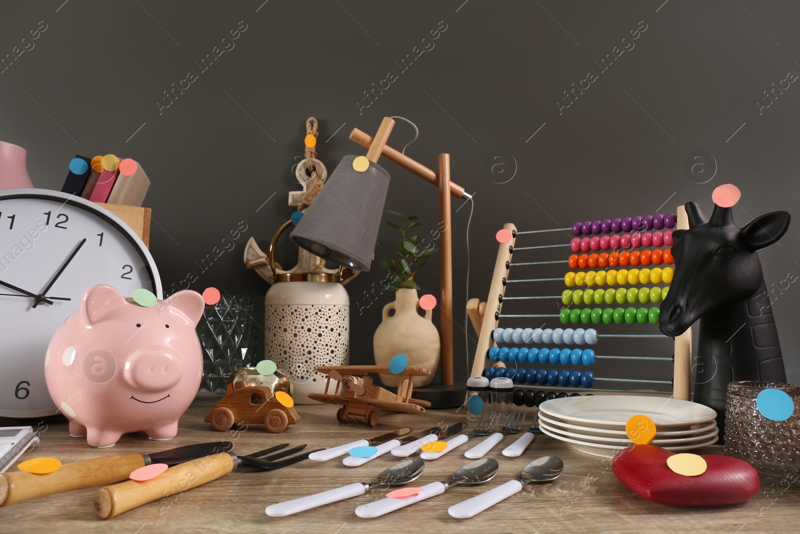 Photo of Many different items on wooden table indoors. Garage sale