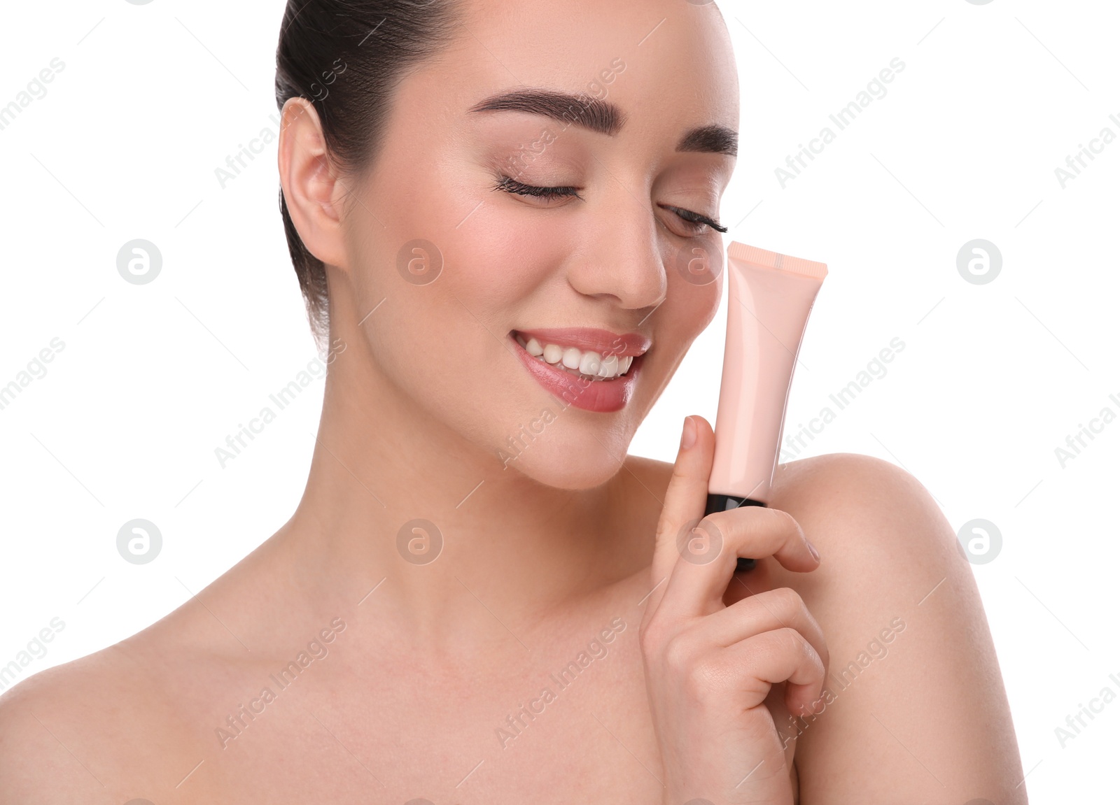 Photo of Woman holding tube of foundation on white background