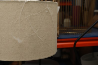 Photo of Old cobweb on lamp in room, closeup