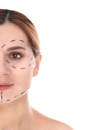 Woman with marks on face for cosmetic surgery operation against white background