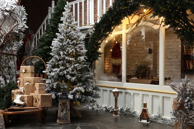 Beautiful Christmas trees, many gift boxes and festive decor indoors. Interior design