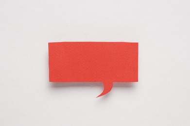 Photo of Red paper speech bubble on white background, top view. Space for text