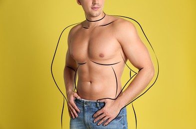 Image of Athletic man after weight loss on yellow background, closeup view