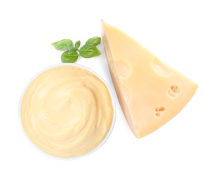 Photo of Tasty cheese, sauce and basil on white background, top view