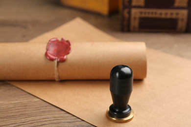 Notary's public pen and document with wax stamp on wooden table, closeup