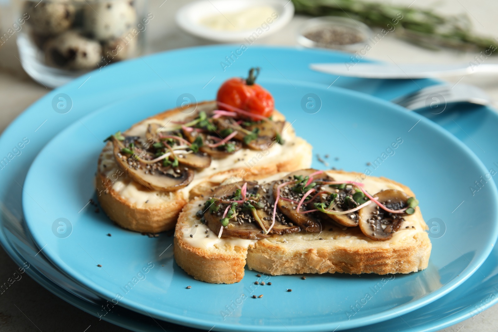Photo of Tasty toasts with mushrooms, sprouts and chia seeds on plate