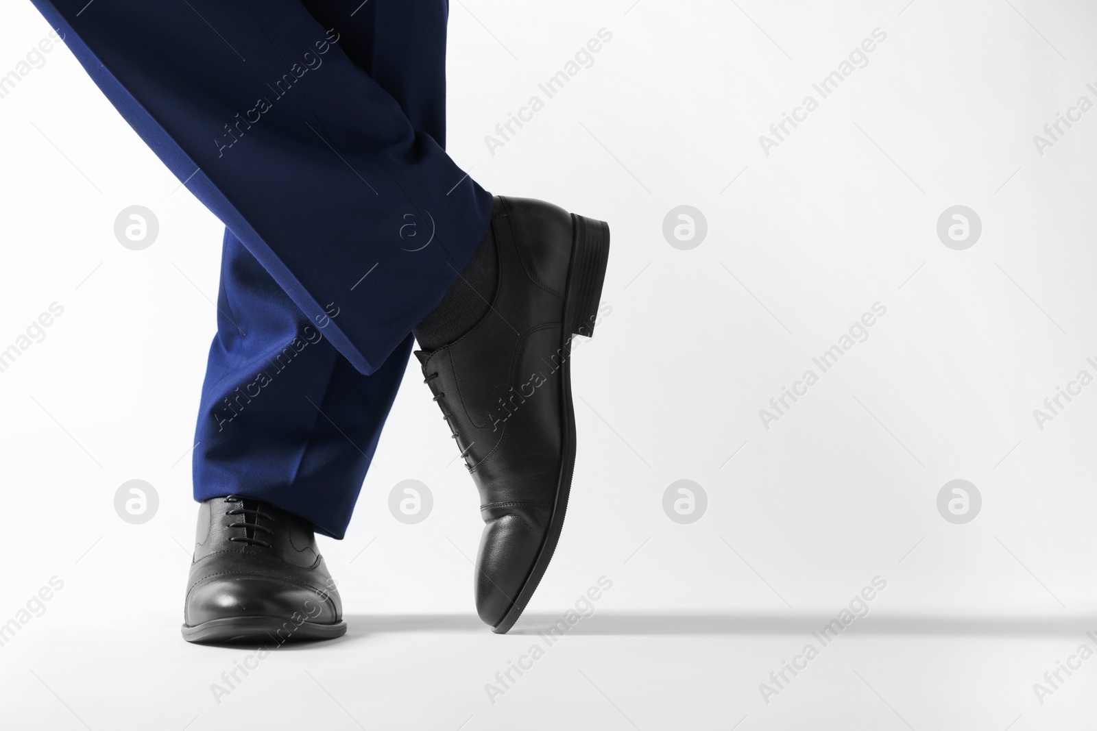 Photo of Businessman in leather shoes on white background, closeup