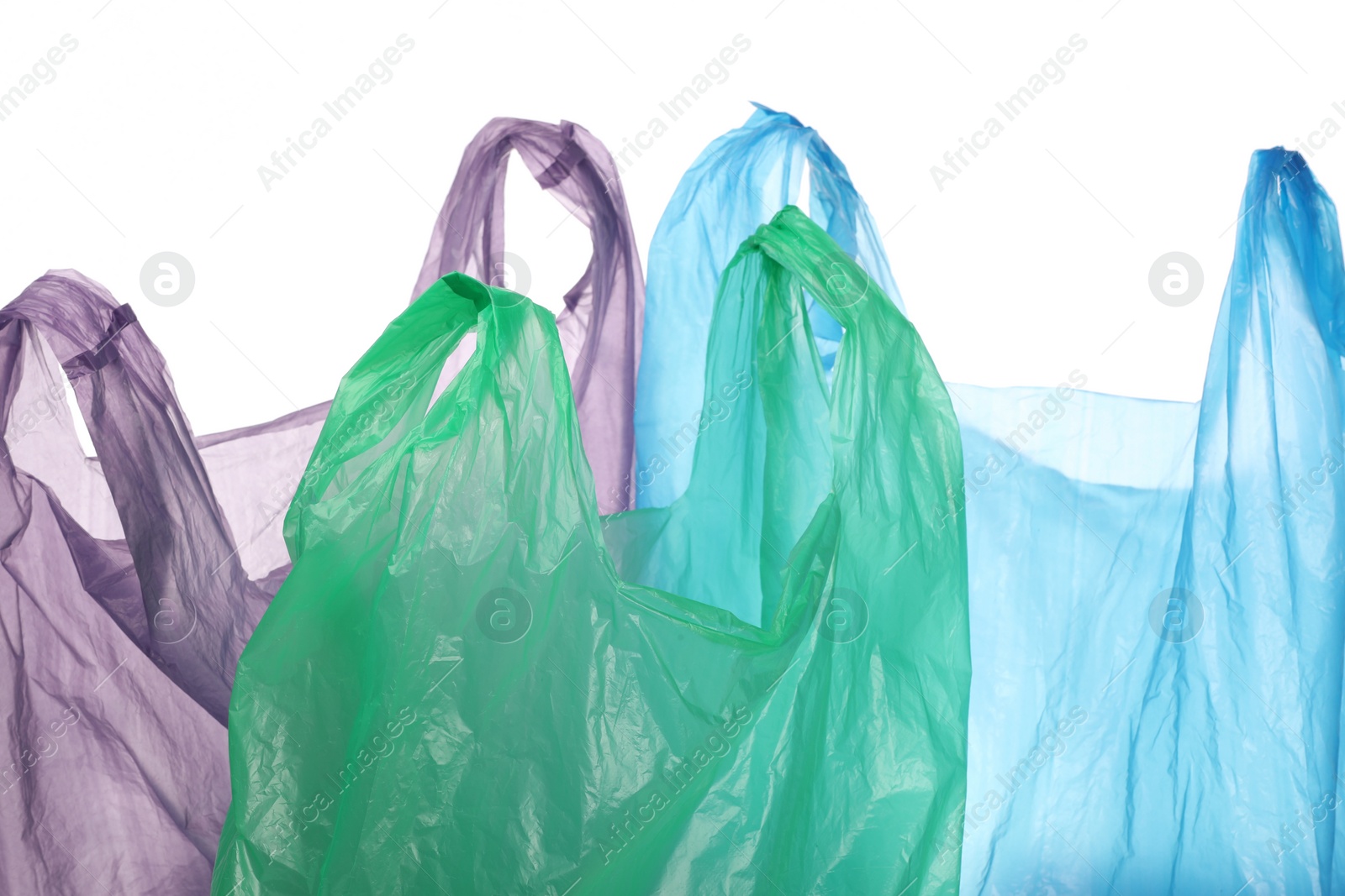 Photo of Many different plastic bags on white background