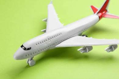 Photo of Toy airplane on green background, closeup view