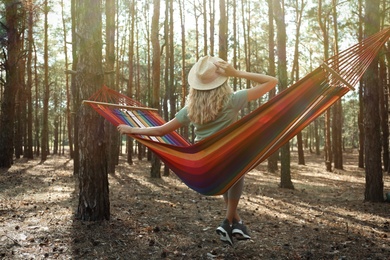 Photo of Woman resting in hammock outdoors on summer day