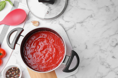 Delicious tomato sauce on white marble table, flat lay. Space for text