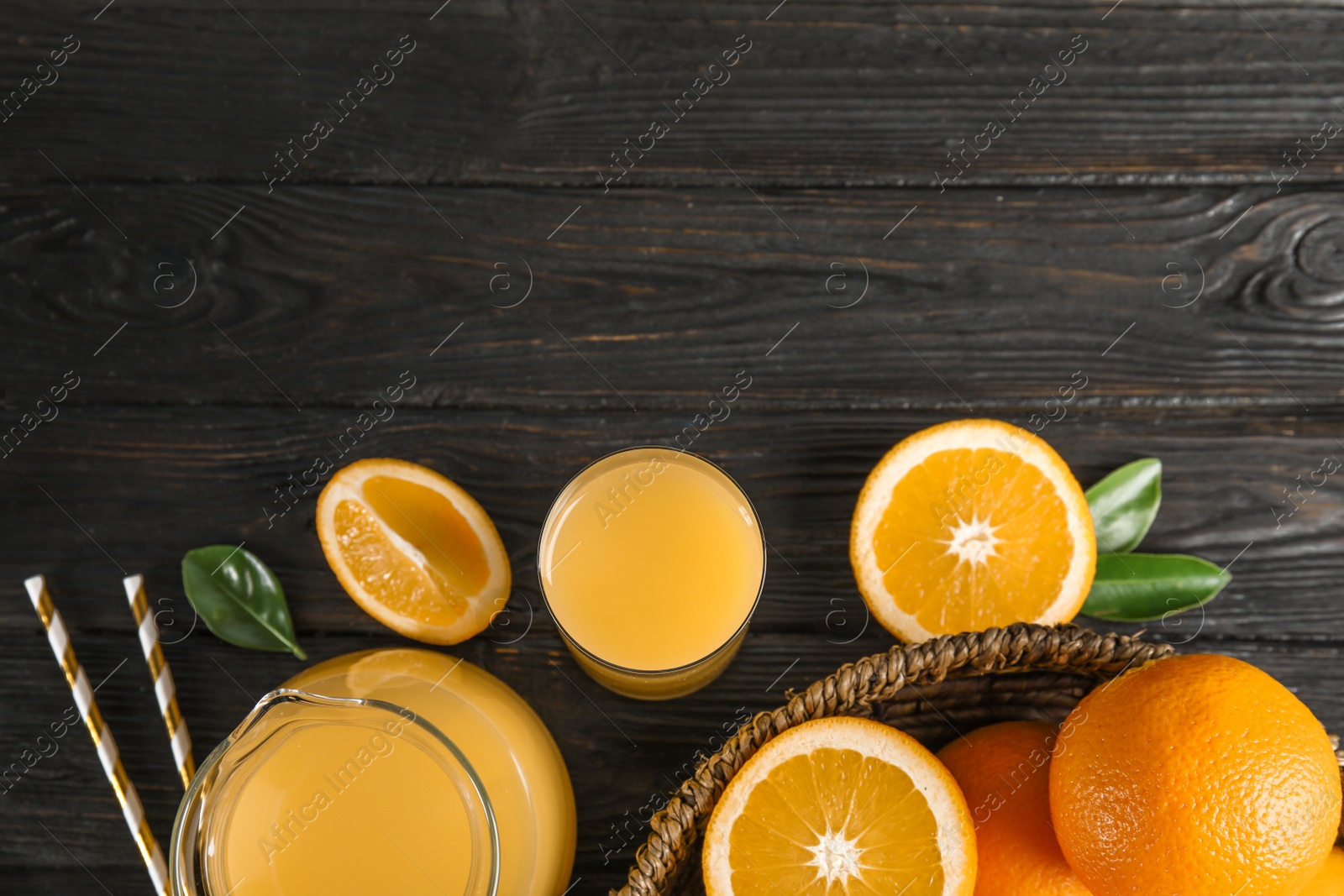 Photo of Composition with fresh orange juice on wooden background, flat lay. Space for text