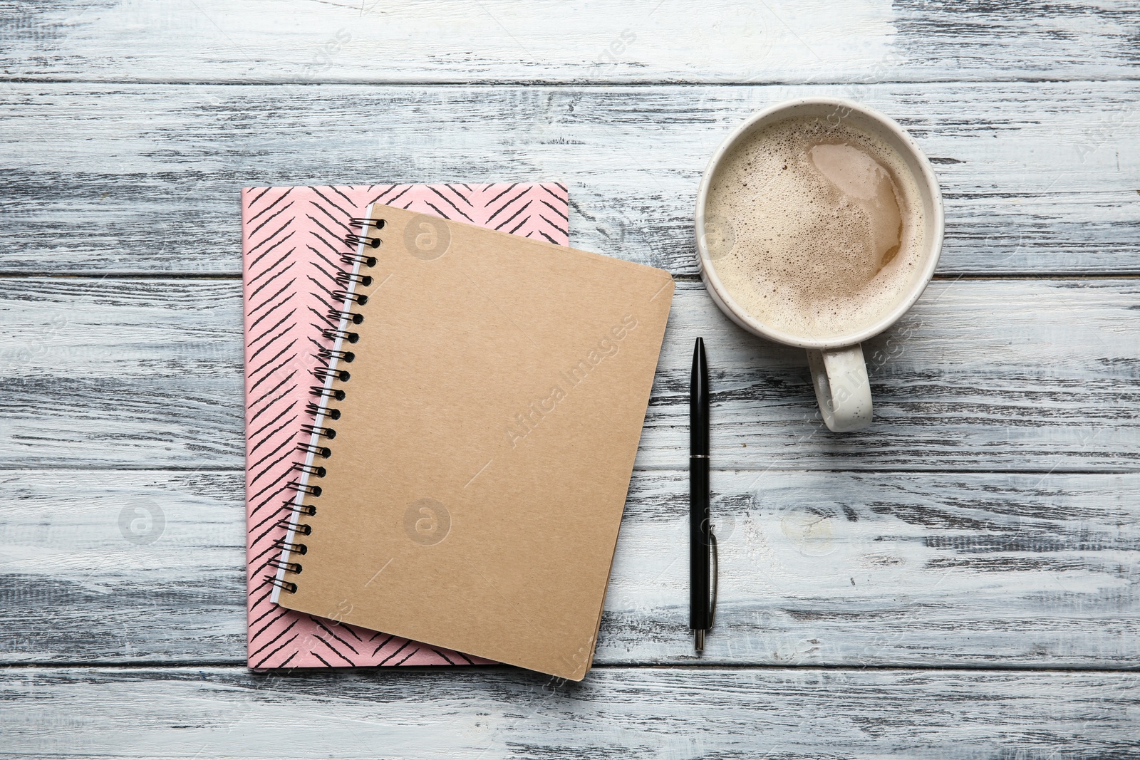 Photo of Flat lay composition with office stationery and cup of coffee on grey wooden table. Space for design