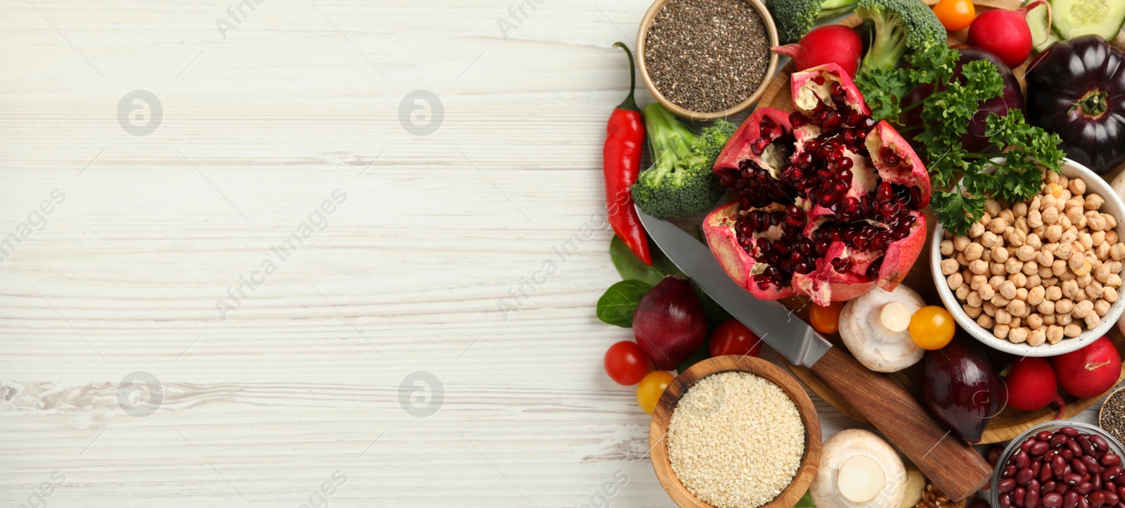 Image of Different vegan food products on white wooden table, flat lay. Banner design with and space for text