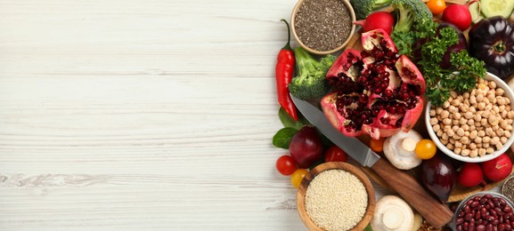 Image of Different vegan food products on white wooden table, flat lay. Banner design with and space for text