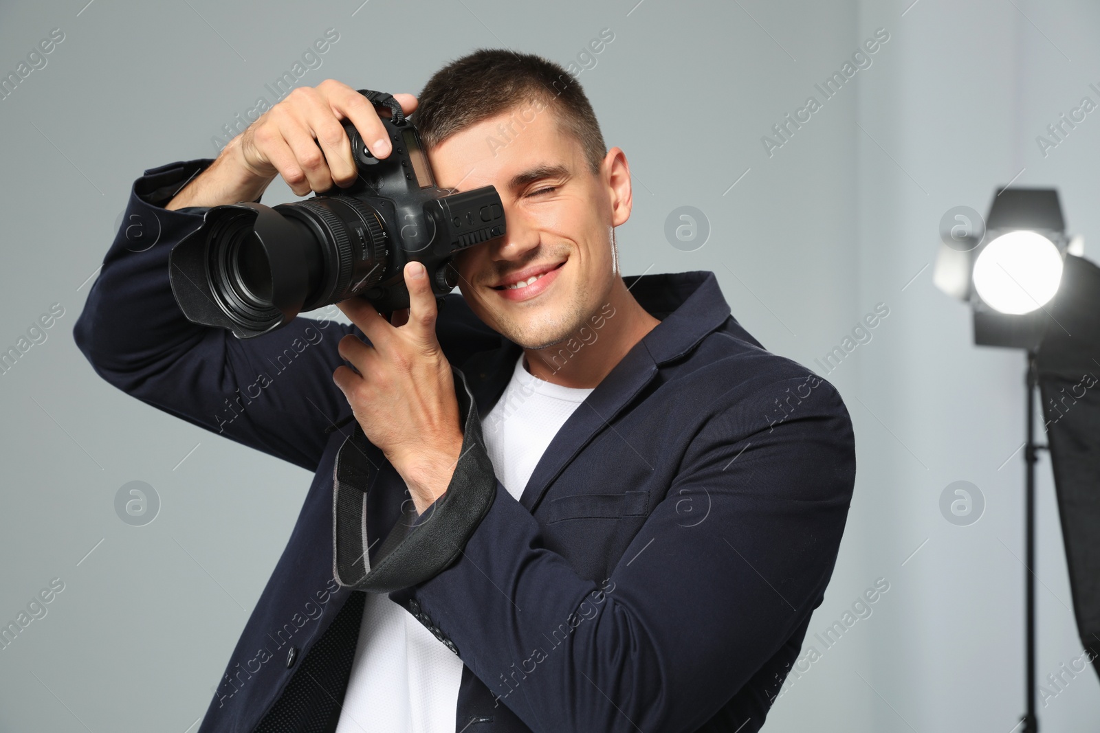 Photo of Professional photographer taking picture in modern studio