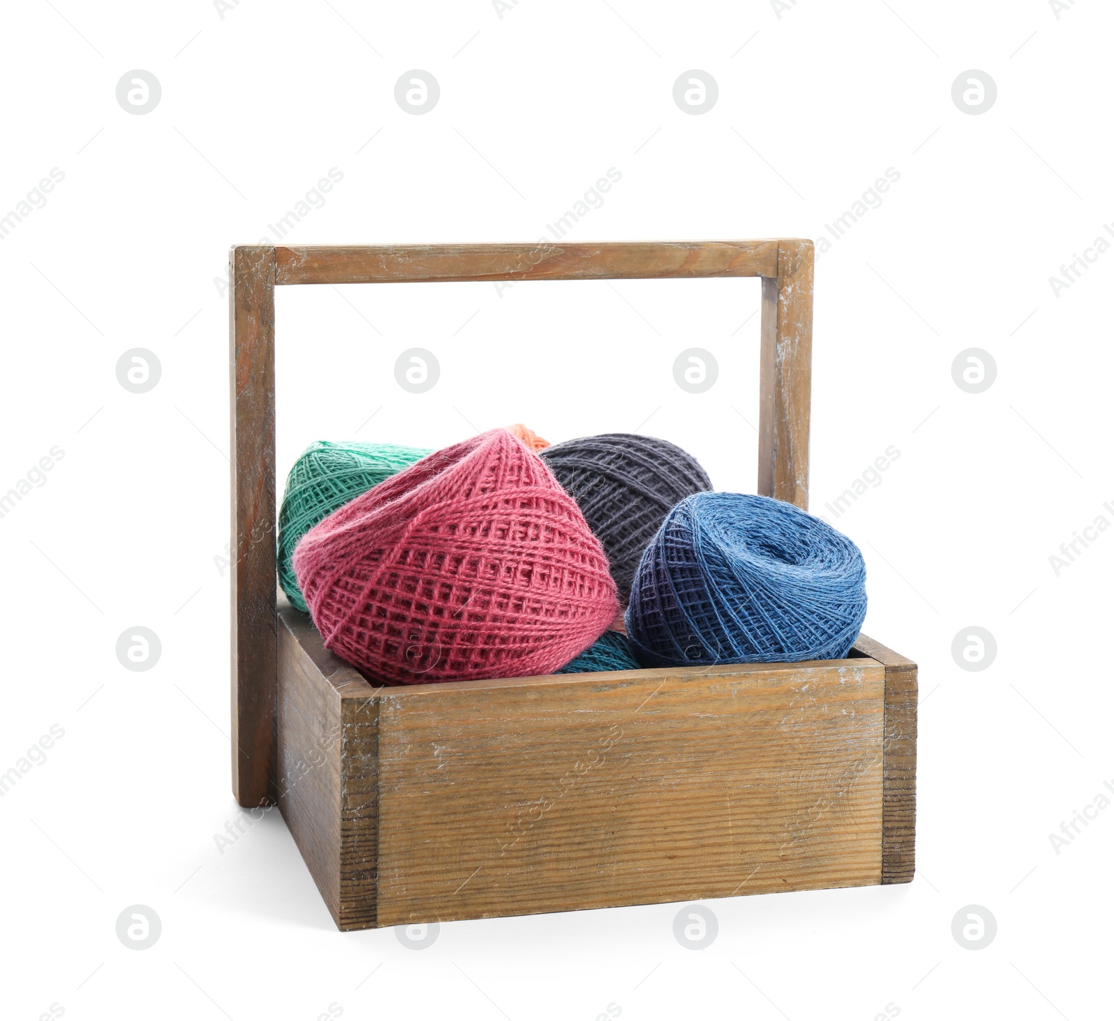 Photo of Wooden basket with clews of colorful knitting threads on white background