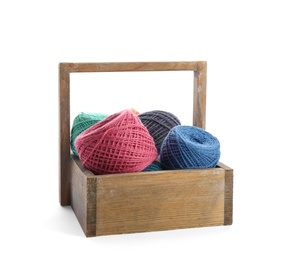 Photo of Wooden basket with clews of colorful knitting threads on white background