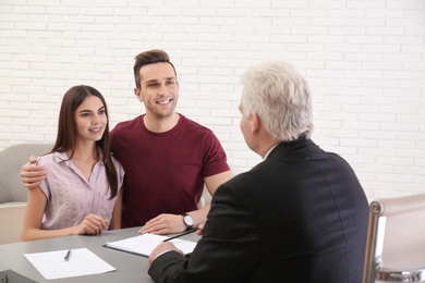 Lawyer having meeting with young couple in office