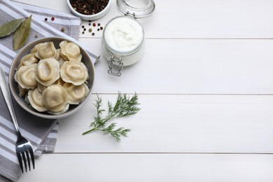 Photo of Delicious dumplings served on white wooden table, flat lay. Space for text