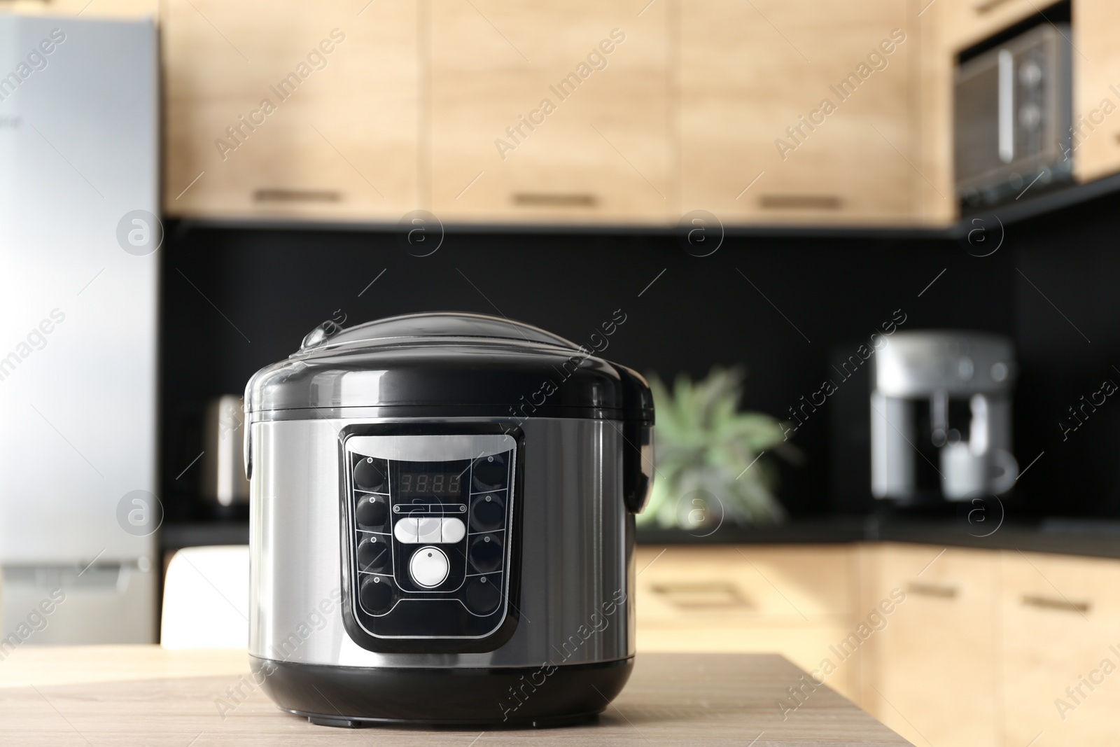 Photo of Modern multi cooker on table in kitchen, space for text