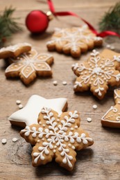 Photo of Tasty Christmas cookies on wooden table, closeup