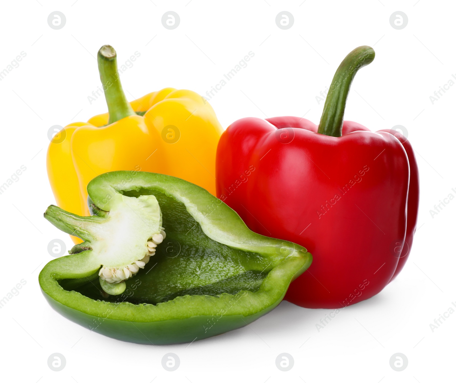 Photo of Whole and cut bell peppers isolated on white