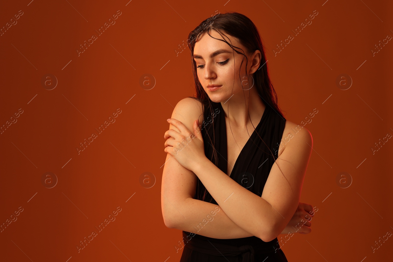 Photo of Portrait of beautiful woman on brown background. Space for text