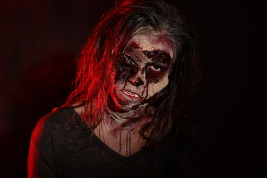 Scary zombie on dark background. Halloween monster