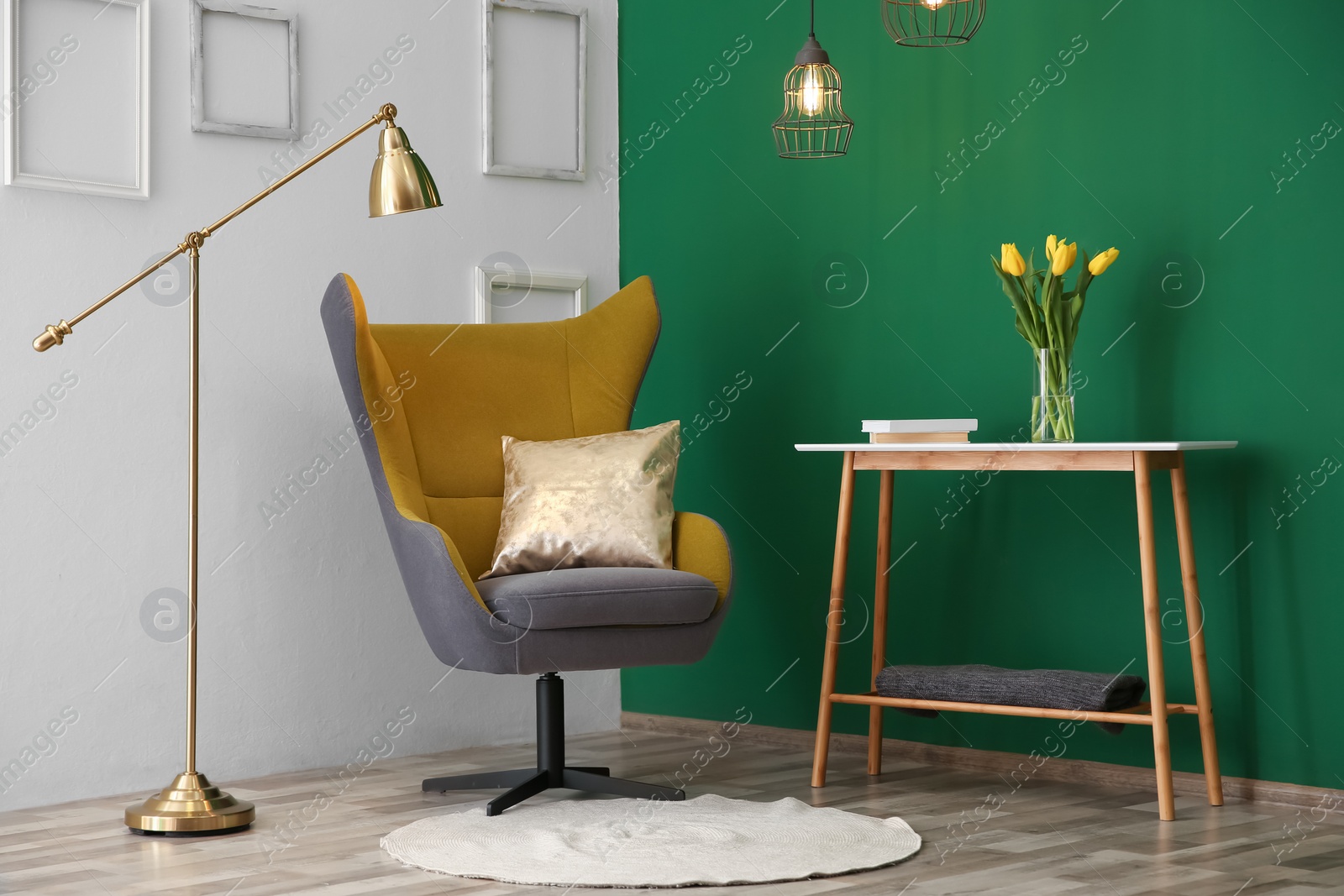 Photo of Modern interior with comfortable armchair and table near color wall