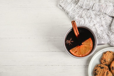 Photo of Flat lay composition with cup of hot mulled wine on white wooden table, space for text. Winter drink