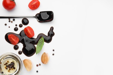 Photo of Organic balsamic vinegar and cooking ingredients on white background, flat lay. Space for text