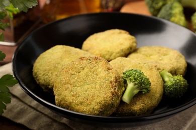 Tasty vegan cutlets with broccoli on table, closeup