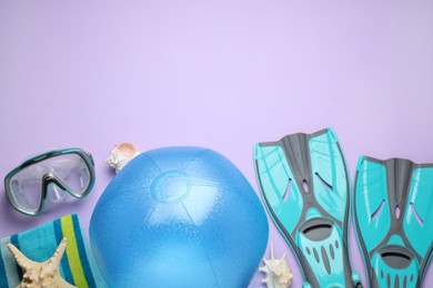 Photo of Flat lay composition with beach ball and other accessories on violet background. Space for text