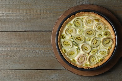 Photo of Tasty leek pie on wooden table, top view. Space for text