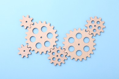 Photo of Business process organization and optimization. Scheme with wooden figures on light blue background, top view