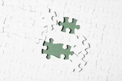 Photo of Blank white puzzle with separated pieces on grey background, flat lay