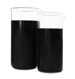Photo of Beakers with black crude oil isolated on white