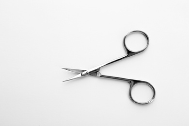 Photo of Pair of nail scissors on white background