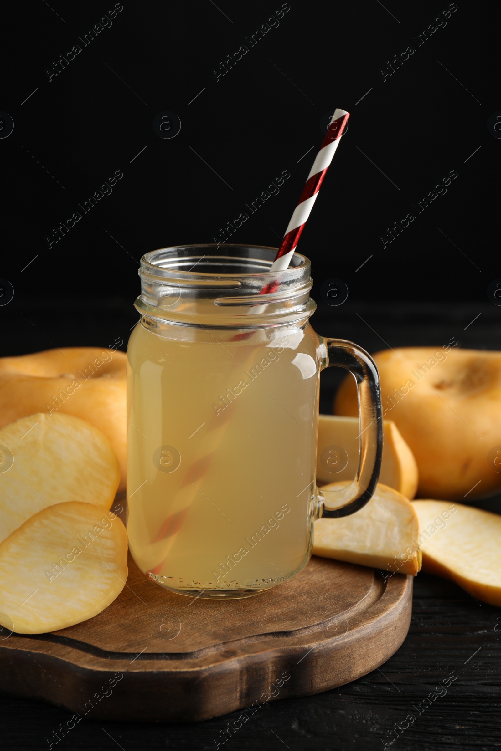 Photo of Freshly made turnip juice on black wooden table