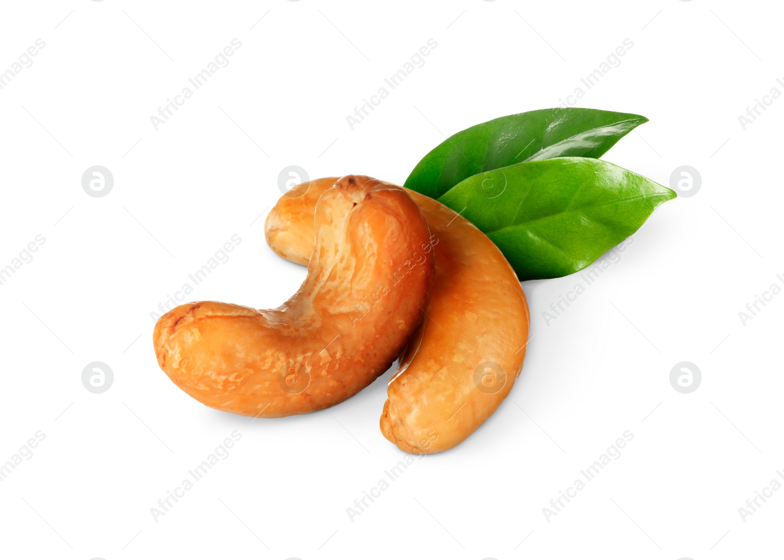 Image of Tasty cashew nuts and fresh green leaves on white background 