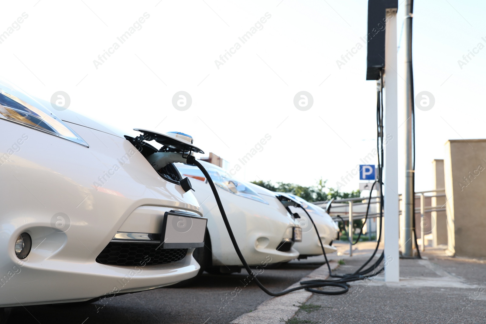 Photo of Charging modern electric cars from station outdoors