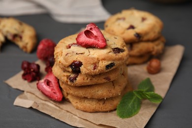 Photo of Cookies with freeze dried fruits and mint on grey table, closeup